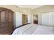 Spacious bedroom with ample closet space and views into an en-suite bathroom at 6465 Watercrest Way # 404, Lakewood Ranch, FL 34202