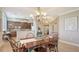 Dining area with chandelier lighting and views into the kitchen and entry at 6465 Watercrest Way # 404, Lakewood Ranch, FL 34202