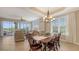 Charming dining area with chandelier, view to the lanai and lots of natural light at 6465 Watercrest Way # 404, Lakewood Ranch, FL 34202