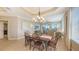 Dining area with a chandelier, a table for six and a view to the lanai and living room at 6465 Watercrest Way # 404, Lakewood Ranch, FL 34202