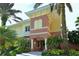 Charming multi-story townhouse with tropical landscaping and a welcoming front entrance at 6465 Watercrest Way # 404, Lakewood Ranch, FL 34202