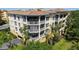 Exterior view of a building featuring multiple screened lanais with great natural light and landscaping at 6465 Watercrest Way # 404, Lakewood Ranch, FL 34202