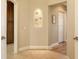 Welcoming hallway with decorative niche, tile flooring, and access to various rooms at 6465 Watercrest Way # 404, Lakewood Ranch, FL 34202