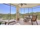 Relaxing screened lanai with comfortable seating, a table and views of the lush surroundings at 6465 Watercrest Way # 404, Lakewood Ranch, FL 34202