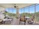 Relaxing screened lanai offers comfortable seating and a dining area with stunning views of the surrounding nature at 6465 Watercrest Way # 404, Lakewood Ranch, FL 34202