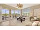 Cozy living room with a ceiling fan, lanai access, comfortable seating, and stylish decor at 6465 Watercrest Way # 404, Lakewood Ranch, FL 34202