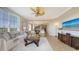 Bright living room with large windows, fan, and elegant furnishings at 6465 Watercrest Way # 404, Lakewood Ranch, FL 34202