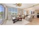 Living area with view to dining space, ceiling fan, lanai access, comfortable seating, and stylish decor at 6465 Watercrest Way # 404, Lakewood Ranch, FL 34202