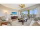 Inviting living room featuring neutral tones, access to a screened lanai, and comfortable seating at 6465 Watercrest Way # 404, Lakewood Ranch, FL 34202