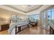 Inviting main bedroom featuring tray ceilings, balcony access, and hardwood floors at 6465 Watercrest Way # 404, Lakewood Ranch, FL 34202