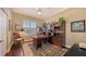 This home office features hardwood floors, beautiful built-in shelving, and a large desk, perfect for working from home at 6465 Watercrest Way # 404, Lakewood Ranch, FL 34202