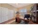 Functional office space features a large desk and built-in shelving at 6465 Watercrest Way # 404, Lakewood Ranch, FL 34202