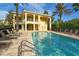Exterior view of building showing pool with lounge chairs, and a jacuzzi area at 6465 Watercrest Way # 404, Lakewood Ranch, FL 34202