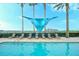 Resort-style pool with lounge chairs, palm trees, and shade structure for relaxing outdoors at 6465 Watercrest Way # 404, Lakewood Ranch, FL 34202