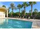 Community pool with lounge chairs overlooking green space and palm trees in a bright setting at 6465 Watercrest Way # 404, Lakewood Ranch, FL 34202