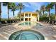 View of the community pool with jacuzzi, lounge chairs, and manicured landscaping at 6465 Watercrest Way # 404, Lakewood Ranch, FL 34202