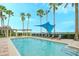 Enjoy this pool with several lounge chairs, pergola, palm trees, and lake views at 6465 Watercrest Way # 404, Lakewood Ranch, FL 34202