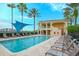 Beautiful pool area with lounge chairs and building with balconies surrounded by lush landscaping at 6465 Watercrest Way # 404, Lakewood Ranch, FL 34202