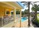 Inviting community pool with palm trees and shaded lounging areas visible from a private balcony at 6465 Watercrest Way # 404, Lakewood Ranch, FL 34202