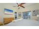 Bedroom with waterfront views, a ceiling fan, and a television at 6748 Fairview Ter # 4-202, Bradenton, FL 34203