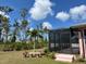 View of screened-in pool area and back yard at 7286 Mineola Rd, Englewood, FL 34224