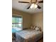 Bedroom view with a ceiling fan and pool view from window at 7286 Mineola Rd, Englewood, FL 34224
