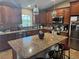 Beautiful kitchen with stainless steel appliances, an island, and granite countertops at 7286 Mineola Rd, Englewood, FL 34224