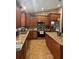 Spacious kitchen with stainless steel appliances and granite countertops and wooden cabinets at 7286 Mineola Rd, Englewood, FL 34224
