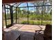 Enjoy the beautiful view from this screened in patio with comfortable seating at 7286 Mineola Rd, Englewood, FL 34224