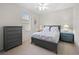 Neutral bedroom featuring a ceiling fan, window, and matching dressers for ample storage at 7424 Arrowhead Run, Lakewood Ranch, FL 34202
