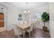 Dining room featuring a wood table, comfortable chairs, hardwood floors, and natural lighting at 7424 Arrowhead Run, Lakewood Ranch, FL 34202