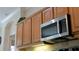 Close-up of kitchen cabinets and stainless steel microwave at 7424 Arrowhead Run, Lakewood Ranch, FL 34202