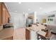 Well-equipped kitchen with stainless appliances, ample cabinet space, and a breakfast bar open to the living area at 7424 Arrowhead Run, Lakewood Ranch, FL 34202