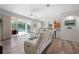 Spacious living room featuring an open layout, comfortable furniture, and access to a screened-in lanai with a pool at 7424 Arrowhead Run, Lakewood Ranch, FL 34202