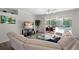 Bright living room with comfortable seating, modern decor, and a view of the pool through sliding glass doors at 7424 Arrowhead Run, Lakewood Ranch, FL 34202