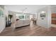 Spacious living room featuring an open layout, hardwood floors, and seamless transitions to other areas at 7424 Arrowhead Run, Lakewood Ranch, FL 34202