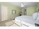 Bright main bedroom featuring a ceiling fan, large window, and an ensuite entrance for easy access at 7424 Arrowhead Run, Lakewood Ranch, FL 34202