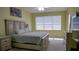 Spacious main bedroom with large window, ceiling fan, and neutral decor at 7424 Arrowhead Run, Lakewood Ranch, FL 34202