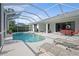 Screened-in pool area with comfortable lounge chairs, outdoor dining set, and a well-maintained pool at 7424 Arrowhead Run, Lakewood Ranch, FL 34202