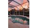 Screened-in pool with steps at sunset perfect for an evening swim at 7424 Arrowhead Run, Lakewood Ranch, FL 34202