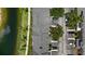 Aerial view of townhome rooftops, parking, and a lush landscape including a serene pond at 7593 Plantation Cir, Bradenton, FL 34201