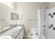 Bathroom featuring double sinks, granite countertops, and shower with black/white tile accents at 7593 Plantation Cir, Bradenton, FL 34201