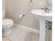 Powder room featuring a pedestal sink, toilet, and neutral wall paint at 7593 Plantation Cir, Bradenton, FL 34201