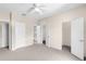 Neutral bedroom offers three doors, carpet, and ceiling fan at 7593 Plantation Cir, Bradenton, FL 34201