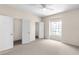 Inviting bedroom with carpet, a ceiling fan, and a closet for storage at 7593 Plantation Cir, Bradenton, FL 34201
