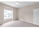Empty bedroom with carpet, ceiling fan, and a window offering natural light at 7593 Plantation Cir, Bradenton, FL 34201