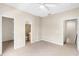 Spacious bedroom with ceiling fan, carpet, and two large closets for storage at 7593 Plantation Cir, Bradenton, FL 34201