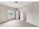 Bright bedroom with neutral tones, carpet flooring, and a ceiling fan at 7593 Plantation Cir, Bradenton, FL 34201