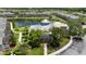 Picturesque clubhouse with palm trees, a serene lake backdrop, and well-maintained landscaping at 7593 Plantation Cir, Bradenton, FL 34201