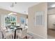 Elegant dining area features a glass table with seating for six and a view of the pond at 7593 Plantation Cir, Bradenton, FL 34201